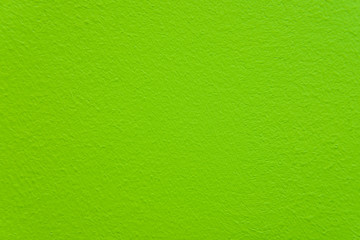 Texture of paint on the wall with bumps. Background of green grungy painted surface