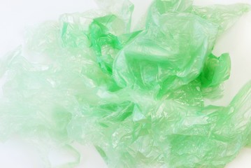 A pile of plastic bags on a white background. The concept of pollution with plastic waste, stop using plastic, an environmentally friendly lifestyle. Close-up, Top view, copy space for text.
