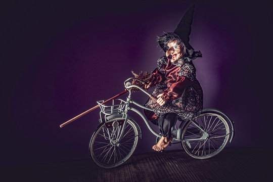 Old witch riding a retro bicycle
