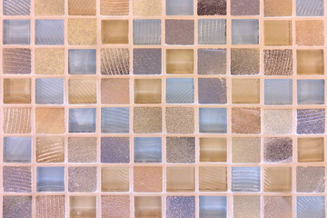 Texture of ceramic tiles in yellow, blue and beige color, close-up