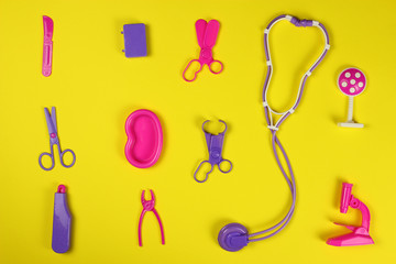 Toy set of doctor's tools on a yellow background