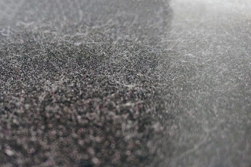 Dusty surface background on dark background, close-up texture