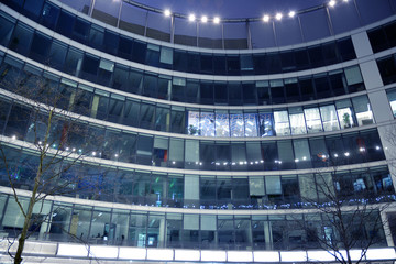 Night architecture - building with glass facade.  Abstract image of office building
