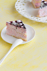 Delicious slices of cake with strawberry cream and coconut, yellow background, creamy dessert, holiday themes