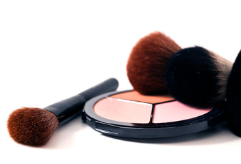 Make-up brushes and cosmetics isolated on a white background.