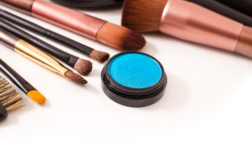 Make-up brushes and cosmetics isolated on a white background.