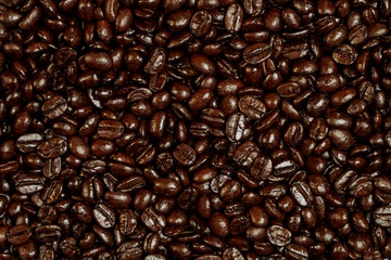 Dark roasted Arabica coffee bean texture background