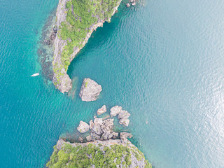 Bird's eye view of the sea in Thailand, crystal clear emerald water and rocks