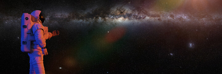 astronaut looking at the Milky Way galaxy  © dottedyeti