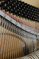 Open mechanism of vintage piano.
Old piano strings. Classical, musical. Selective focus