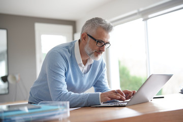 Man in office working on laptop computer