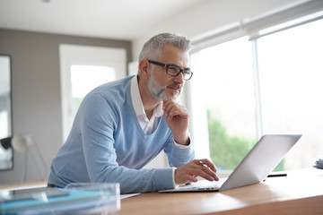 Man in office working on laptop computer