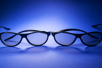 3d  glasses on a blue background for watching interesting movies in the cinema hall