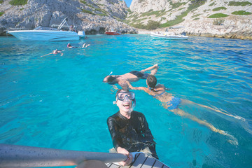 Marseille, France - August 13th, 2019:People are swimming and diving in Calanques de Morgiou, Marseilles, Provence, South of France.  Everyone looks very cheerful and happy.