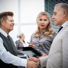 Fototapeta premium close up. businessman and businesswoman greeting each other with a handshake