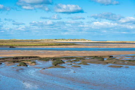 Views of mudflats at low tide at Barnham Overy Staithe in Norfolk, England, UK.