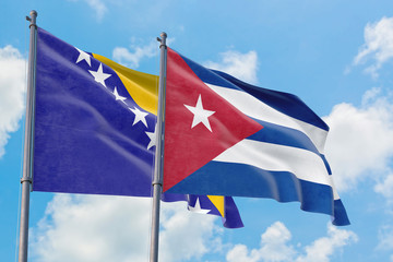 Cuba and Bosnia Herzegovina flags waving in the wind against white cloudy blue sky together. Diplomacy concept, international relations.