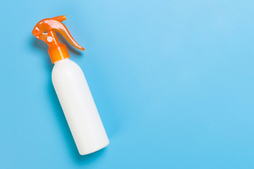 flat lay concept of summer travel vacation. Sunscreen bottle mock up on blue background top view with copy space