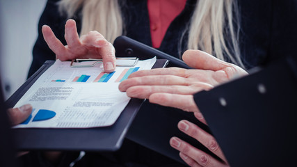 close up. happy businesswoman looking at financial report.