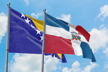 Dominican Republic and Bosnia Herzegovina flags waving in the wind against white cloudy blue sky together. Diplomacy concept, international relations.