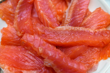 pieces of slightly salted salmon close-up. the basis of the keto diet red oily fish