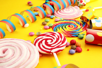 candies with jelly and sugar and streamers. colorful array of different childs sweets and treats.
