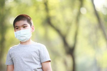 A young Asian boy wear mask to protect against dust PM 2.5 and germs