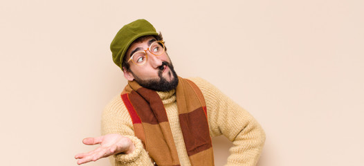 young cool bearded man feeling puzzled and confused, unsure about the correct answer or decision,...