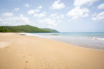 A view of tropical beach with sea, sand and blue sky,during the day on a public beach in Rincon Beach,Samana peninsula, Dominican Republic