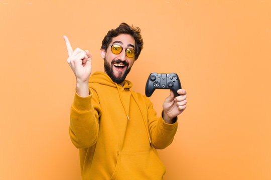 Young Crazy Cool Man Paying With A Game Console Controller