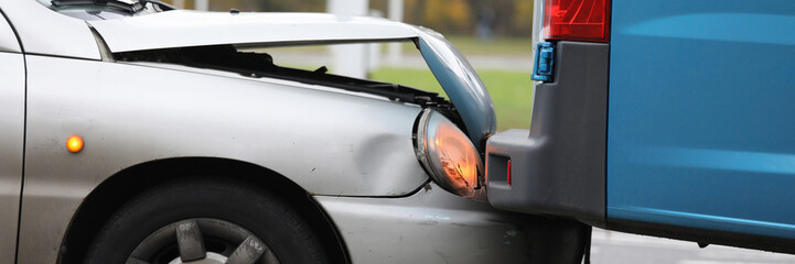 Focus on damaged bumper of vehicle in car accident in city. Damaged parts of transport. Automobile with breakdown and crashed details. Collision of auto on road