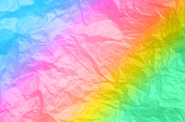 Fototapeta na wymiar Rumpled rainbow background. Real texture of the wrapping texture.