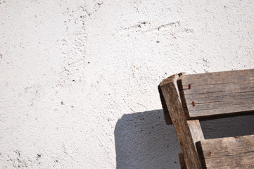 Gray wall texture and wooden object