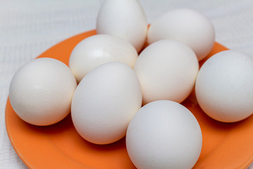 White eggs on the orange plate