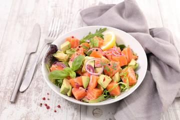 vegetable salad with salmon, avocado, basil and onion