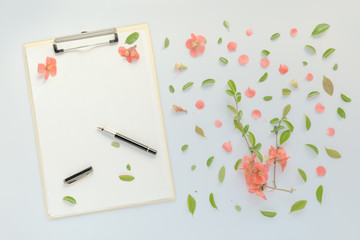 Blank paper on clipboard note pad with floral decoration
