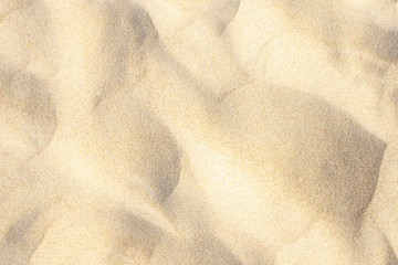 Light sand pattern on beach near sea in summer background