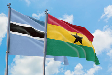 Ghana and Botswana flags waving in the wind against white cloudy blue sky together. Diplomacy concept, international relations.