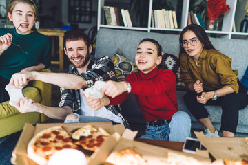 Positive fellows playing on console in living room