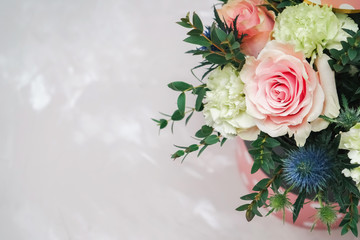 Festive bouquet on a gray marble background. Place for congratulations and inscriptions.