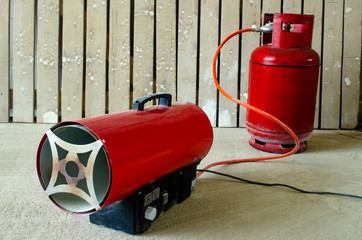 red gas air heater and gas cylinder