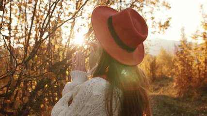 Outdoor autumn fashion portrait of young beautiful confident woman walking at sunset in mountain landscape.