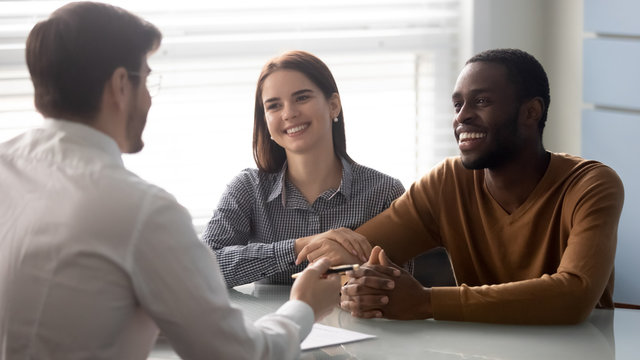 Interracial couple at meeting with financial advisor in office