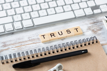 Trust business concept with letters on cubes