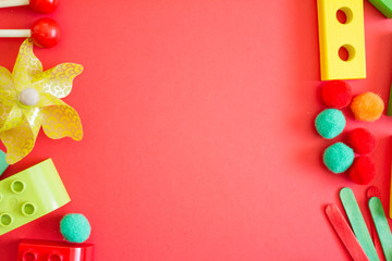 Kids lay Flat. children's toys frame on a red background. Concept of development and education of children. designer, sorter, creativity. the view from the top. Leisure and Hobbies of the child.