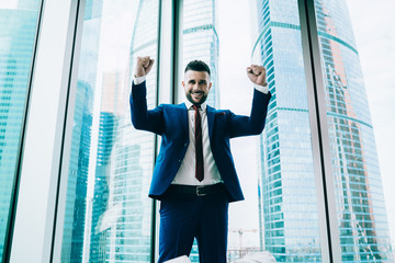 Joyful boss enjoying win in office