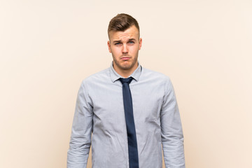 Young blonde businessman over isolated background sad