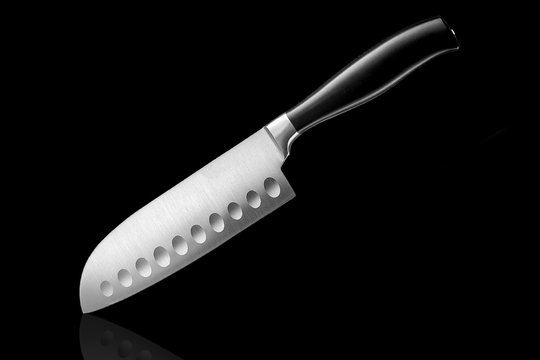 Chrome kitchen knife with stitching on the blade on the table with reflection