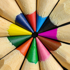 Colored wooden pencils in a circle macro shot.