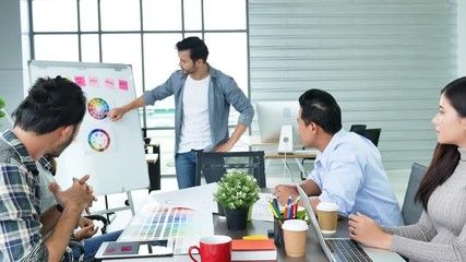 Diverse office team creative agency meeting present design ideas young startup group business people. Casual designer team plan discuss communication business people working together conference room